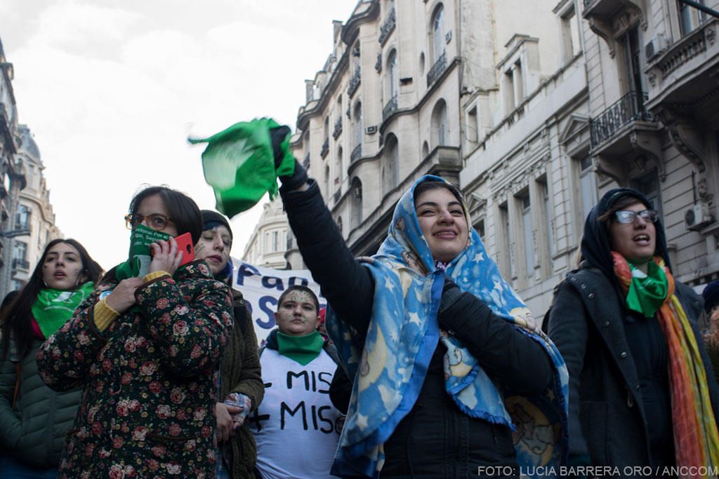 Mujeres marchando con sus pañuelos verdes.